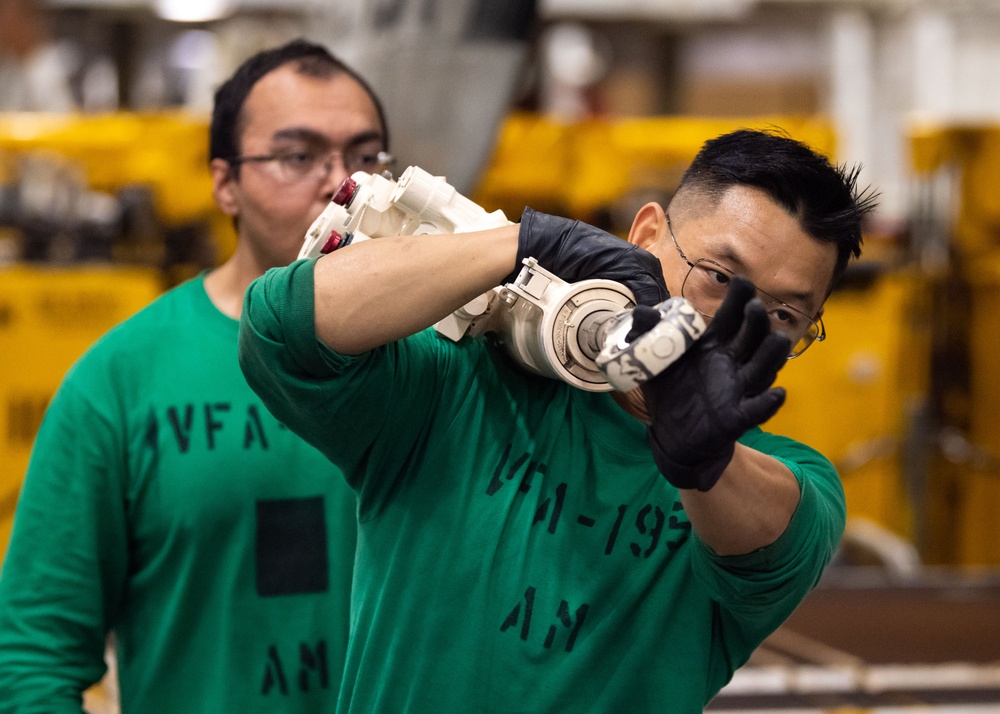 USS Ronald Reagan (CVN 76) Sailors perform maintenance on aircraft while underway