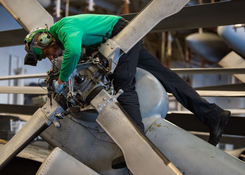 USS Ronald Reagan (CVN 76) Sailors perform maintenance on aircraft while underway