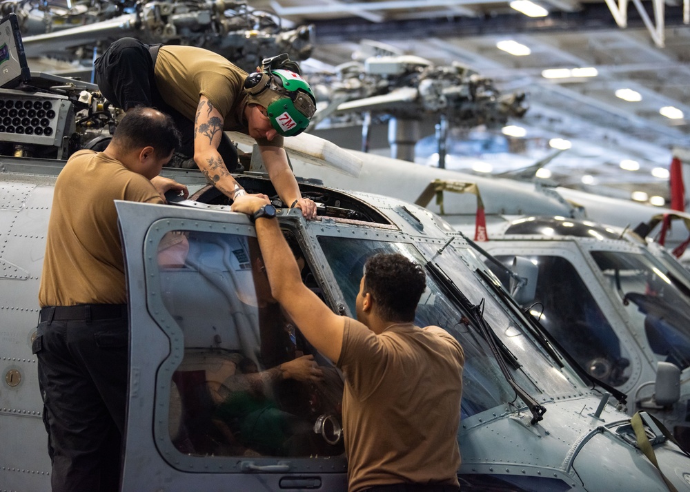 USS Ronald Reagan (CVN 76) Sailors perform maintenance on aircraft while underway