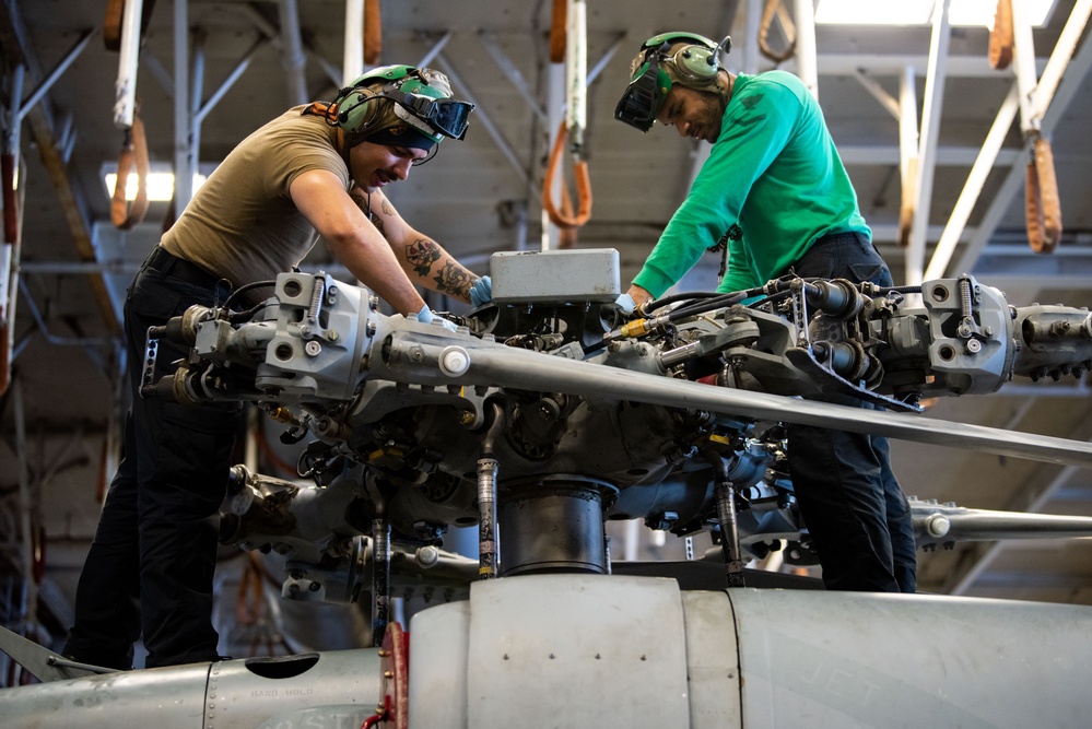 USS Ronald Reagan (CVN 76) Sailors perform maintenance on aircraft while underway