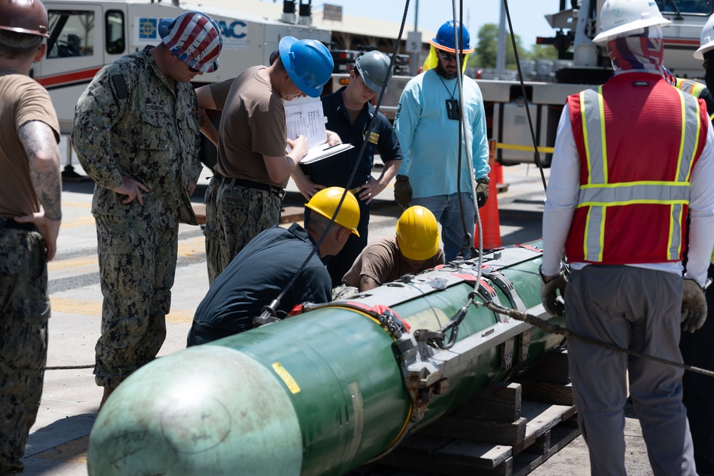 Sailors load torpedoes onto submarine USS Topeka for RIMPAC 2024