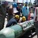 Sailors load torpedoes onto submarine USS Topeka for RIMPAC 2024