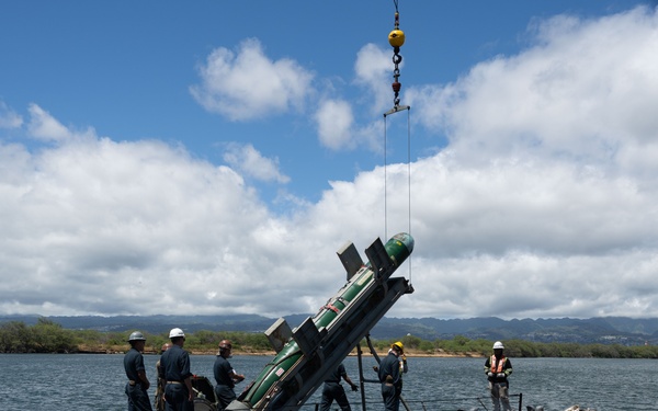 Sailors load torpedoes onto submarine USS Topeka for RIMPAC 2024