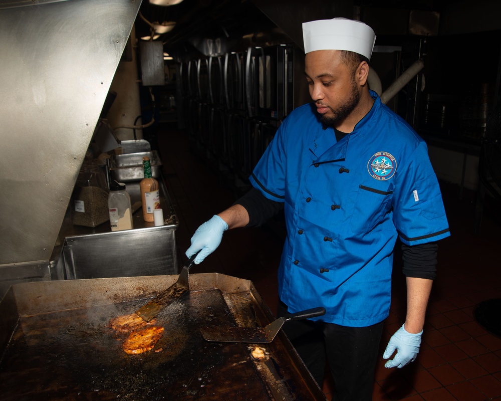 Sailor Cooks In Galley