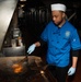 Sailor Cooks In Galley