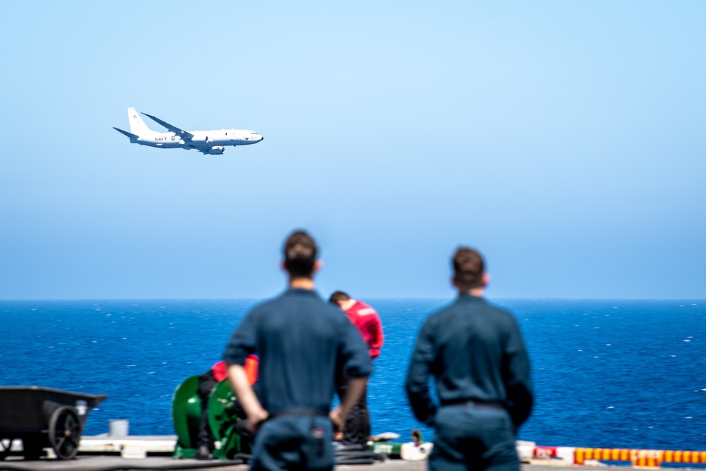 Sailors Observe A P-8A Poseidon Flyby