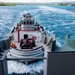 Tugboat guides USS Carl Vinson