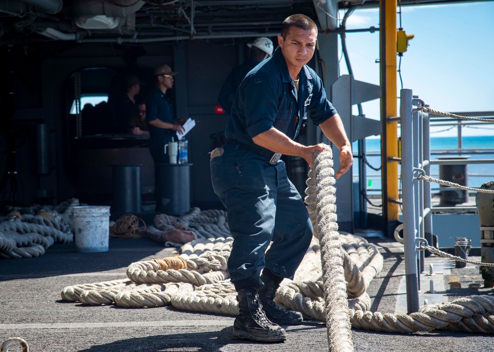 Sailor heaves line aboard USS Carl Vinson