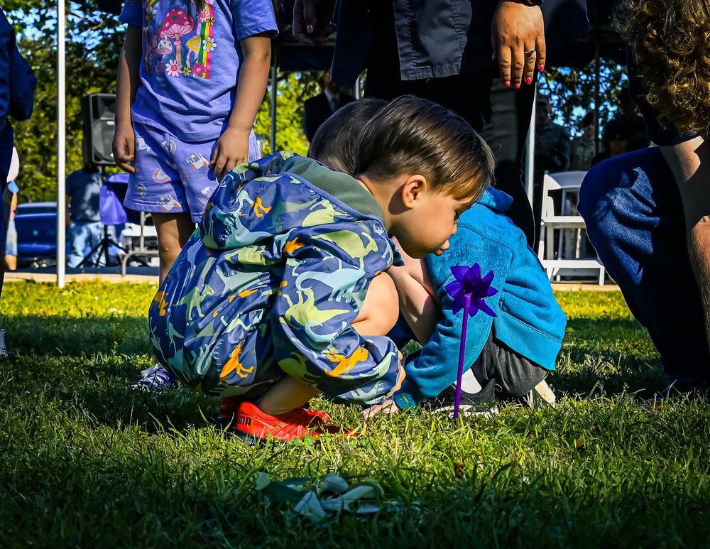 Kid Blowing pinwheel during Military Child Event at Fort Johnson