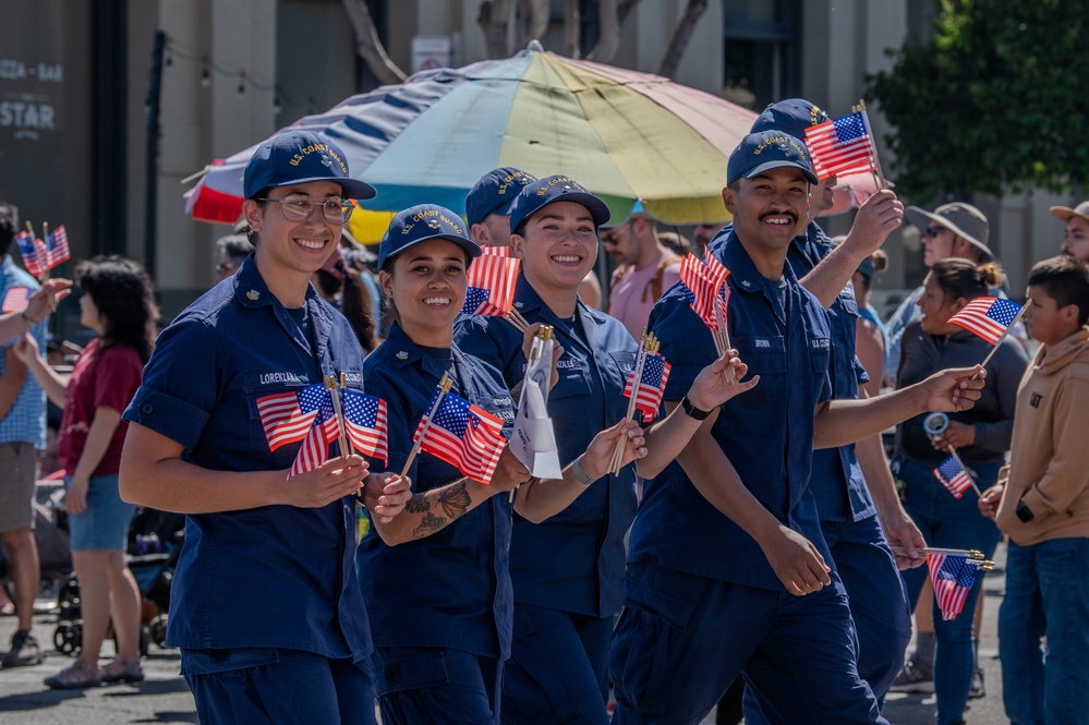 Coast Guard members participate in Fourth of July parade