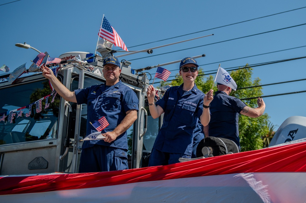 Coast Guard members participate in Fourth of July parade