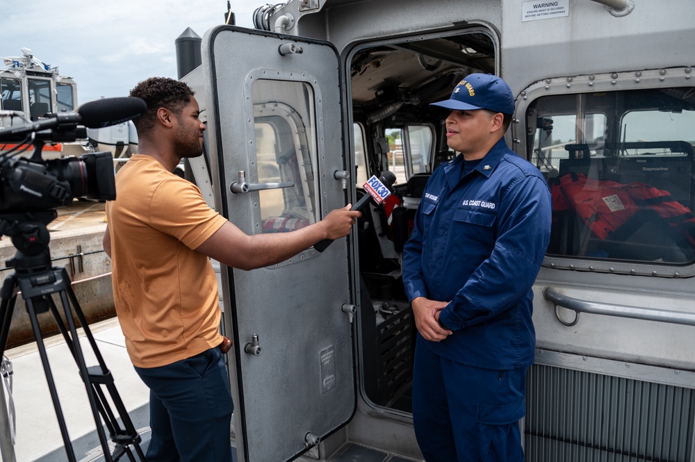 Coast Guard rescue crew conducts interview with local media