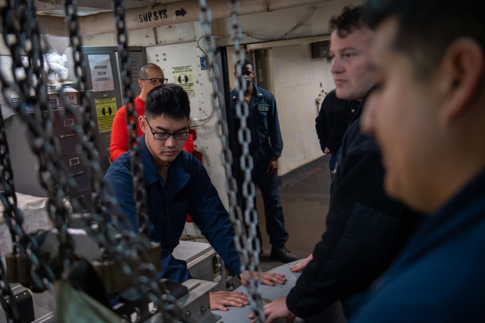 Sailors Hoist An Ordnance Shell