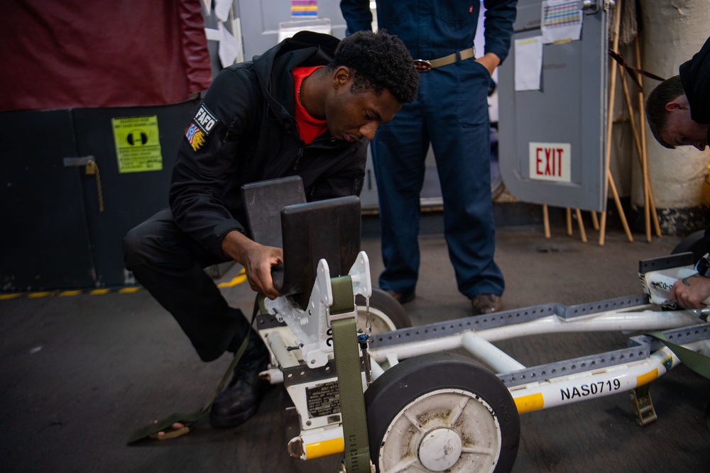 Sailor Prepares A Dolly For Ordnance Transfer