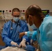 US and Angolan military healthcare teams work together in the ER