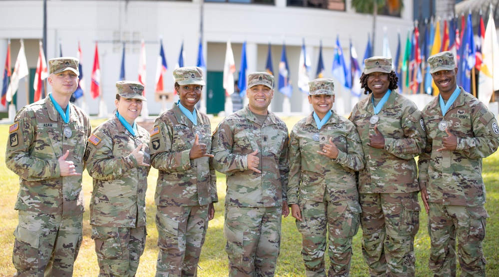 TAMC Soldiers inducted into Sergeant Audie Murphy Club Alaka'i Chapter stand side by side with Command Sgt. Maj. John &quot;Mike&quot; Contreras