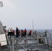 Sailors aboard the USS Howard conduct a replenishment-at-sea with the USNS Big Horn in the South China Sea