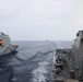 Sailors aboard the USS Howard conduct a replenishment-at-sea with the USNS Big Horn in the South China Sea