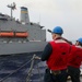 Sailors aboard the USS Howard conduct a replenishment-at-sea with the USNS Big Horn in the South China Sea