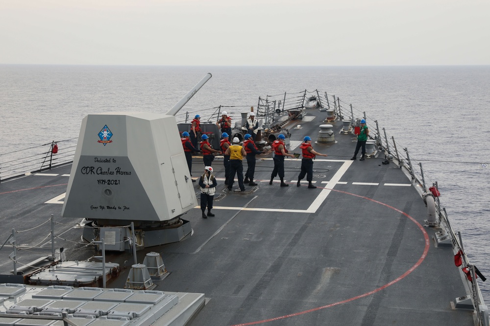 Sailors aboard the USS Howard conduct a replenishment-at-sea with the USNS Big Horn in the South China Sea