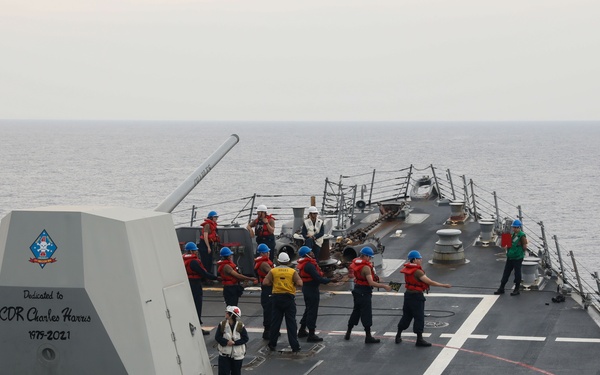 Sailors aboard the USS Howard conduct a replenishment-at-sea with the USNS Big Horn in the South China Sea