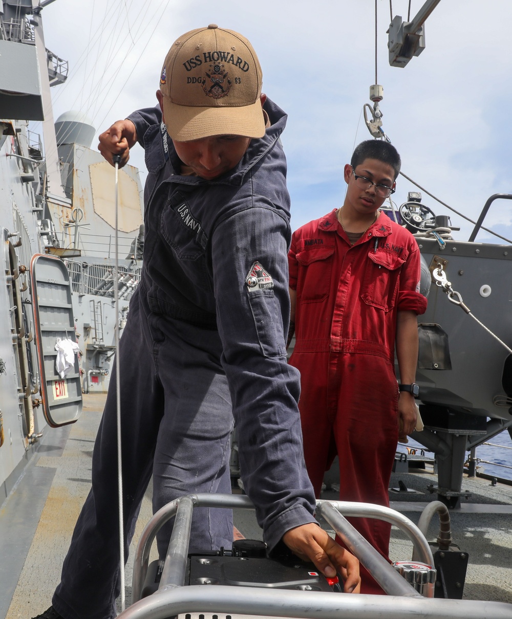 Sailors aboard the USS Howard perform a monthly test on a P-100 in the South China Sea