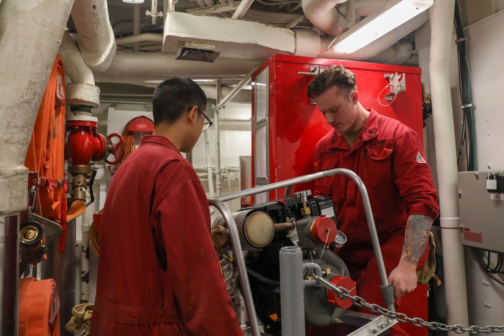 Sailors aboard the USS Howard perform a monthly inspection on a P-100 in the South China Sea
