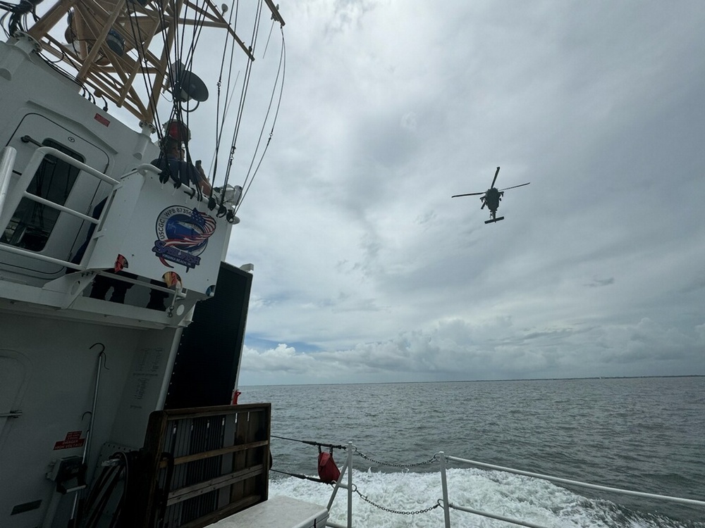 An Mh-60 Jayhawk from Air Station Elizabeth City flies over the CGC Sailfish (WPB-87356) during a search for a missing swimmer off Buckroe Beach in Newport News, Virginia, July 12, 2024. Rescue crews, comprised of federal, state, and local first responders, searched for a combined 80 hours and covered an area more than 700 square miles. (Courtesy photo provided by Master Chief Petty Officer Tim Abrams)