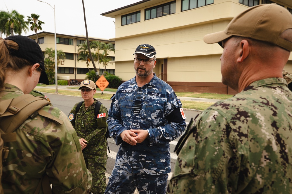 Royal Australian Air Force Group Captain Glenn Pascoe works alongside medical personnel during RIMPAC 2024.jpg