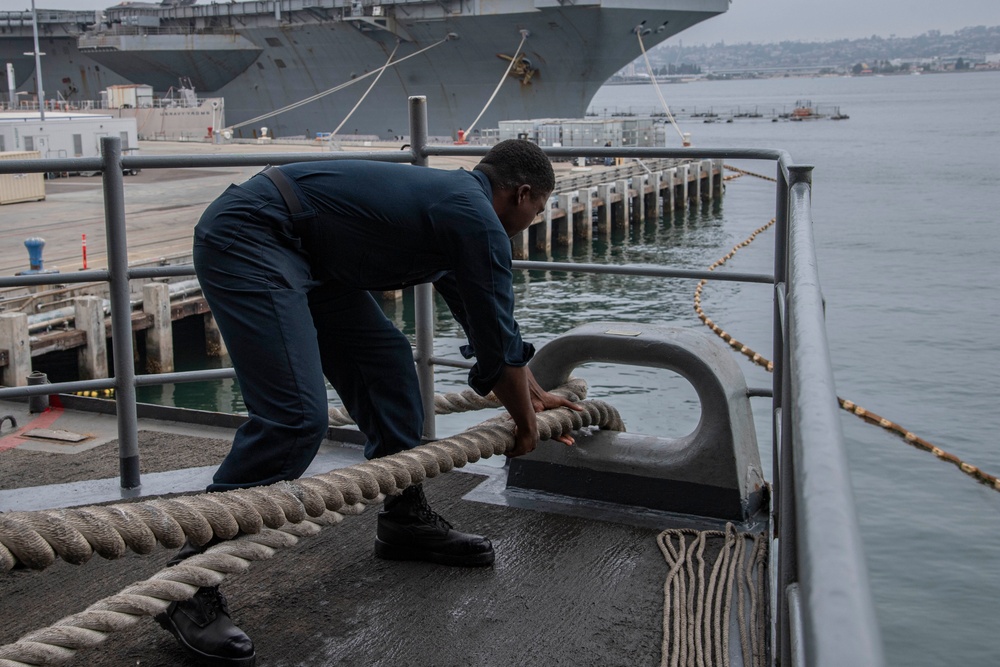 Abraham Lincoln Sailor heaves in line