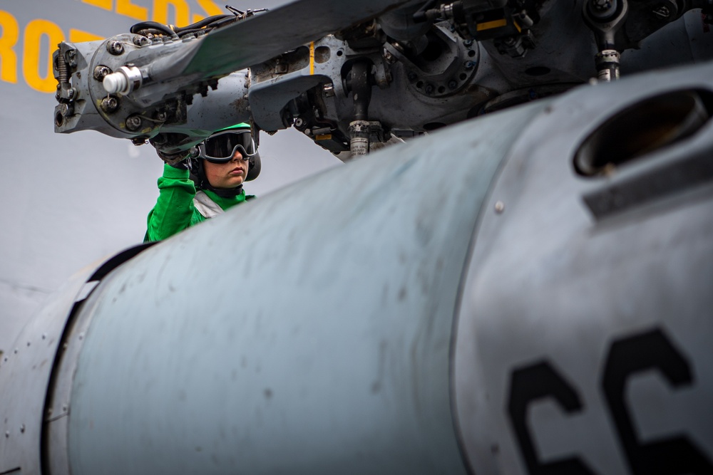 A Nimitz Sailor Performs Maintenance On Aircraft