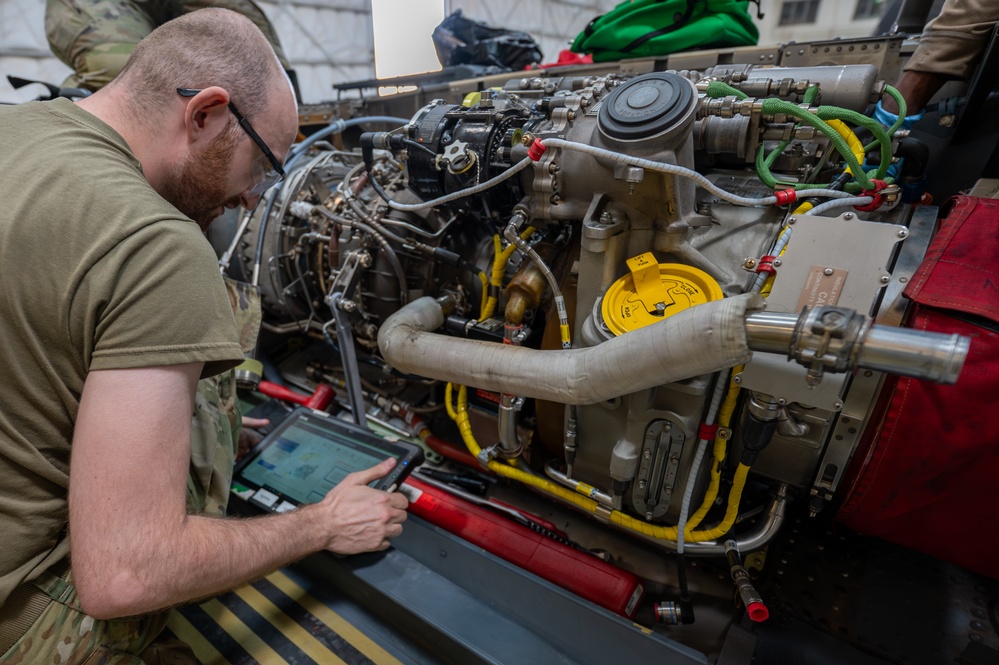 Maintainers change engine on HH-60W Jolly Green II helicopter