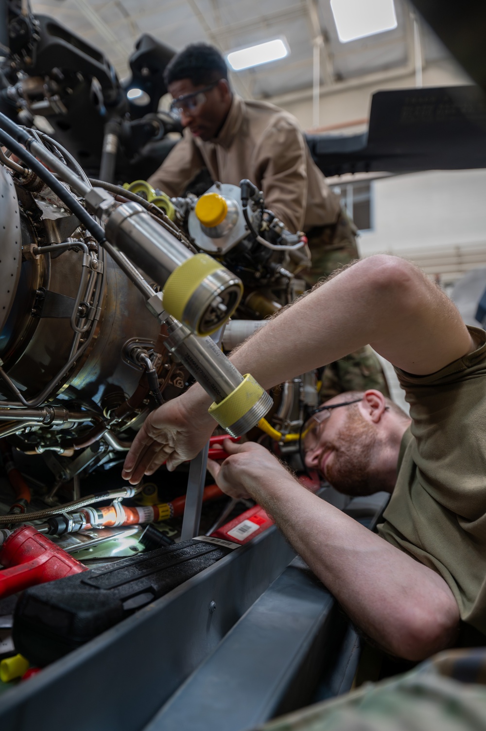 Maintainers change engine on HH-60W Jolly Green II helicopter