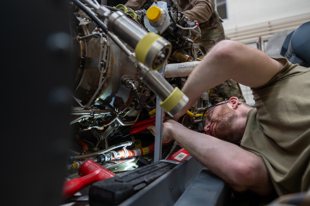 Maintainers change engine on HH-60W Jolly Green II helicopter