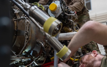 Maintainers change engine on HH-60W Jolly Green II helicopter