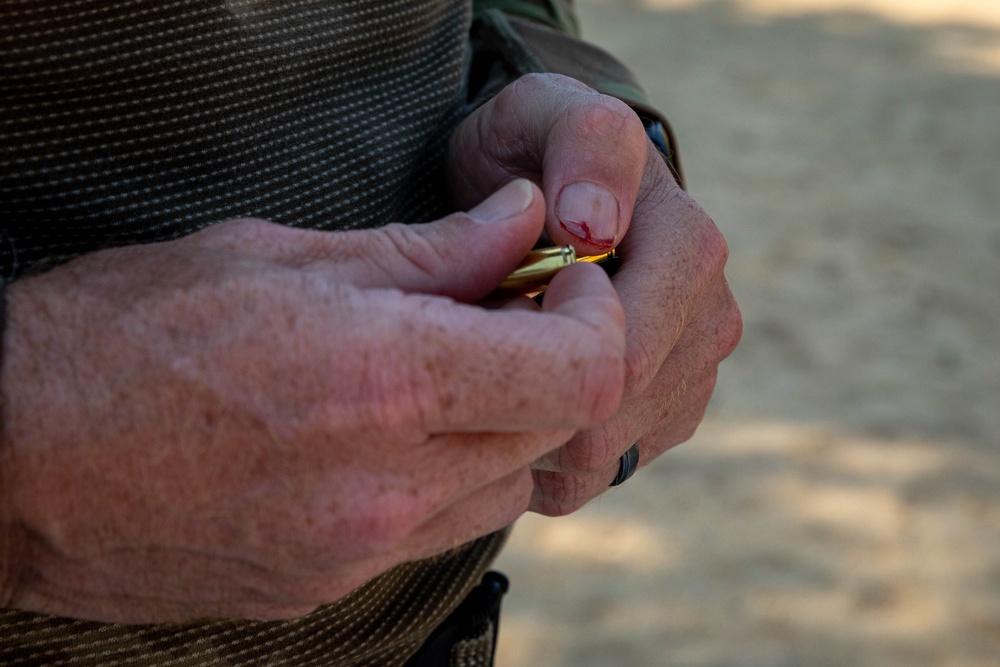 Capt. Zachary Grimes loads a pistol magazine