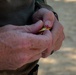 Capt. Zachary Grimes loads a pistol magazine