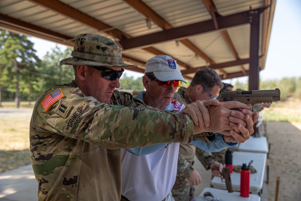 Roger Harvey shows Capt. Zachary Grimes pistol shooting techniques