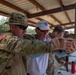 Roger Harvey shows Capt. Zachary Grimes pistol shooting techniques