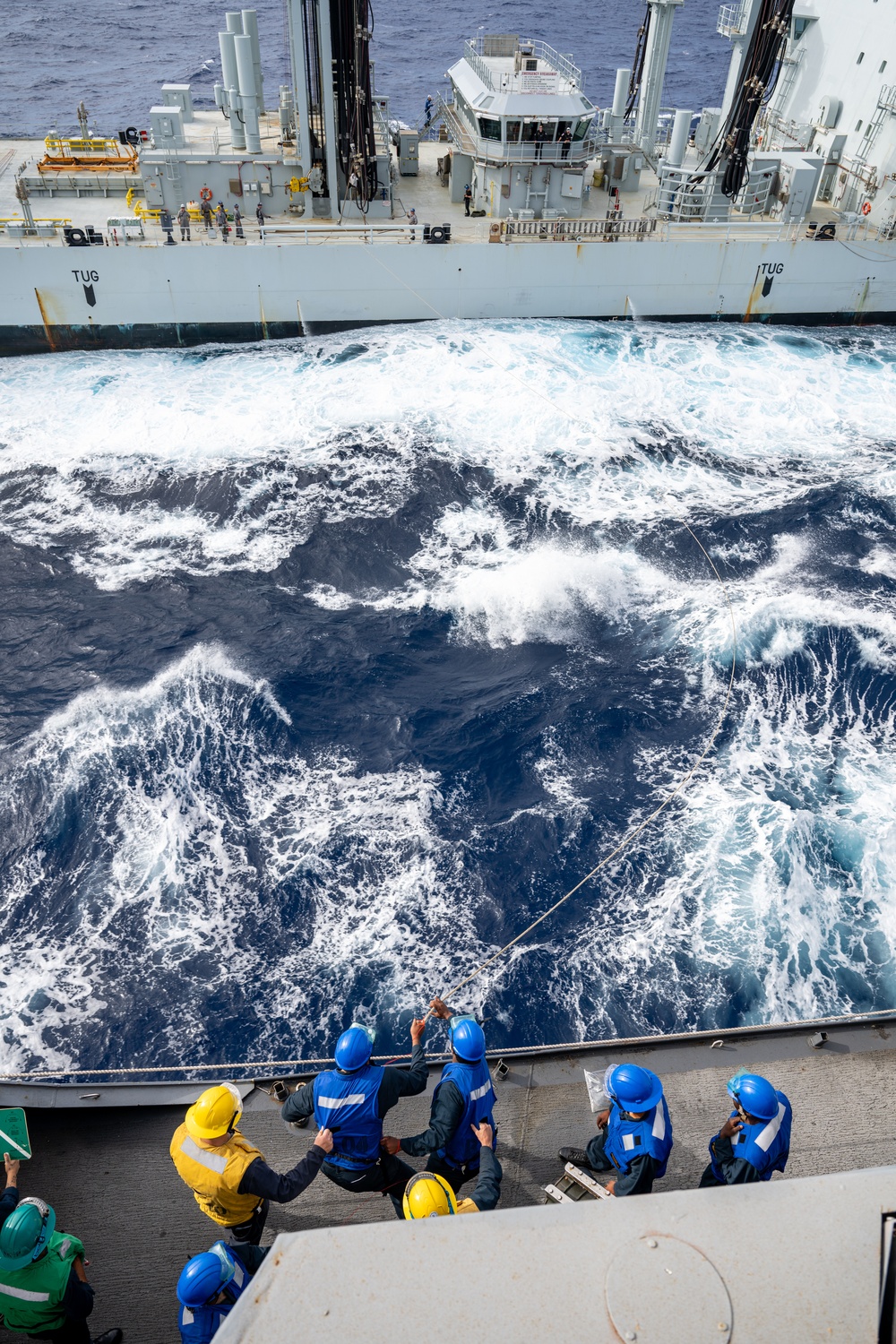 USS Somerset Sailors heave a line alongside Royal Canadian Navy MV Asterix