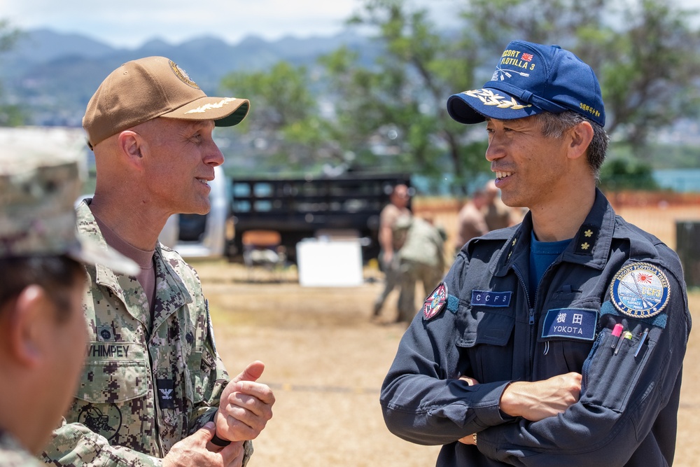 Rear Adm. Kazushi Yokota speaks with U.S. Navy Capt. Doug Whimpey following ENDEX of HADR