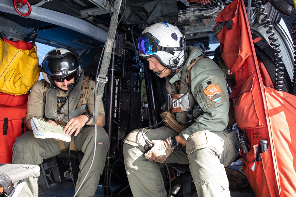 Naval Aircrewmen Review Safety Procedures in Flight During RIMPAC 2024