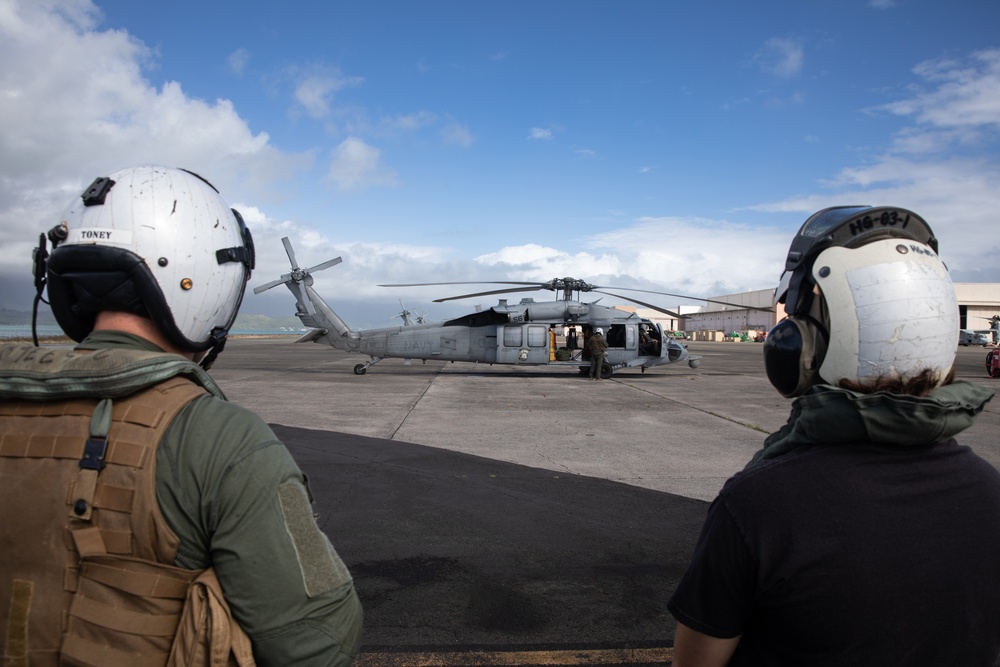 Naval Aircrewmen prepare to board MH-60 Seahawk