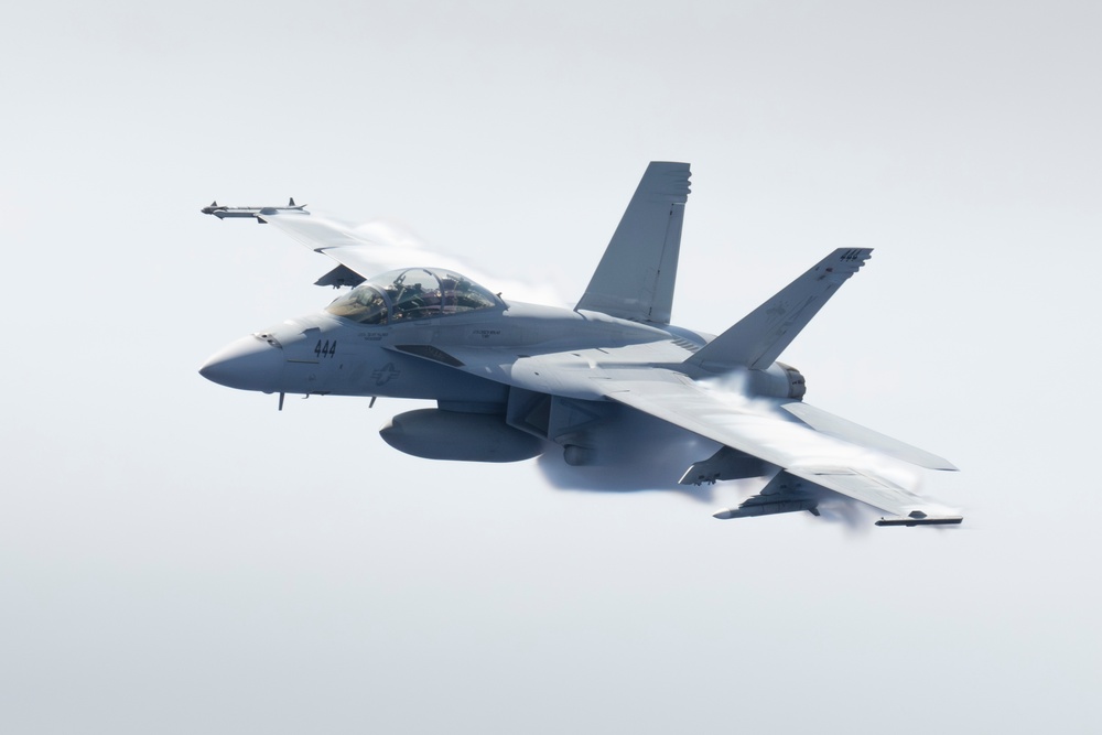 FA-18F Super Hornet flies over HMCS Vancouver
