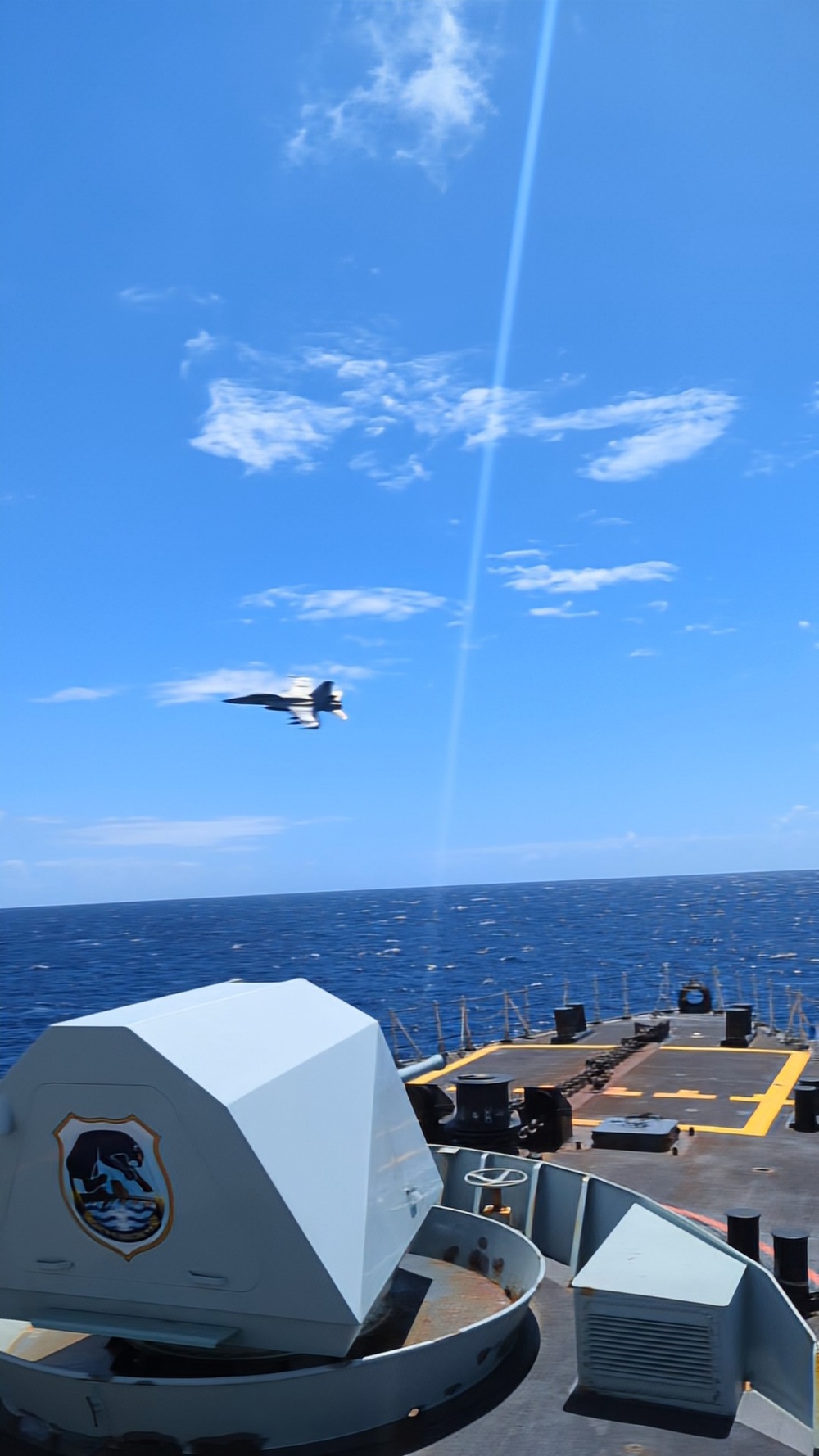 FA-18F Super Hornet flies over HMCS Vancouver