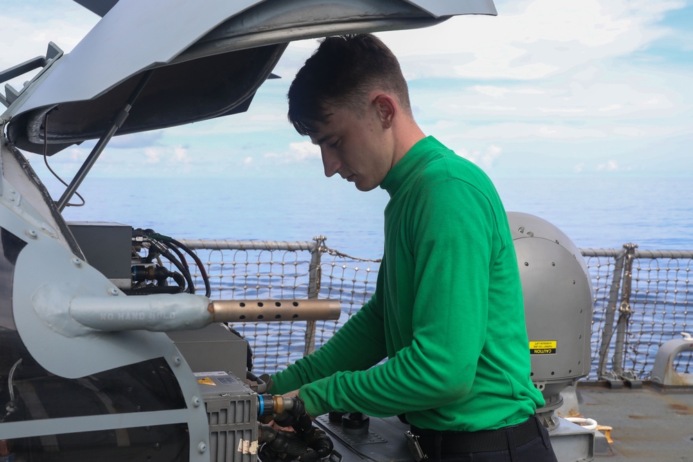 Sailors aboard the USS Howard conduct routine maintenance on a Sea Hawk helicopter in the South China Sea