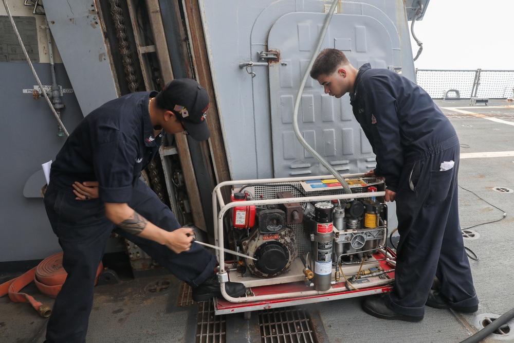 Sailors aboard the USS Howard test an emergency breathing air compressor in the South China Sea