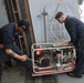 Sailors aboard the USS Howard test an emergency breathing air compressor in the South China Sea