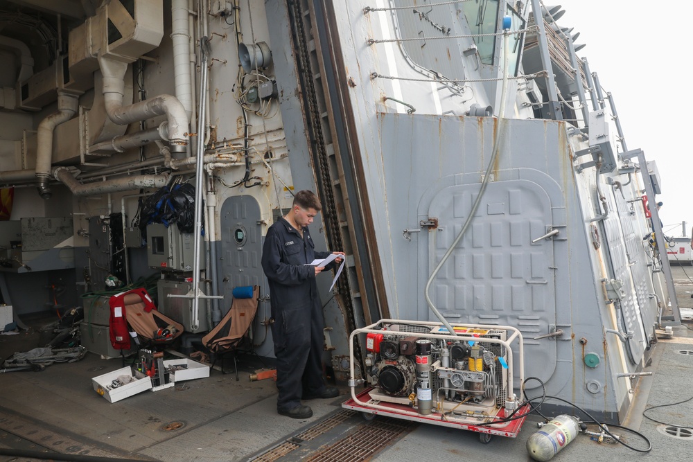 Sailors aboard the USS Howard test an emergency breathing air compressor in the South China Sea