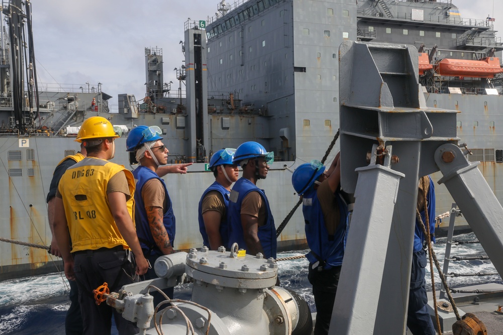Sailors aboard the USS Howard conduct a replenishment-at-sea with the USNS Cesar Chavez in the South China Sea